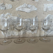 A Set of Four Etched Wine Glasses