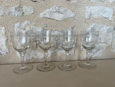 A Set of Four Etched Wine Glasses