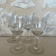 A Set of Four Etched Wine Glasses