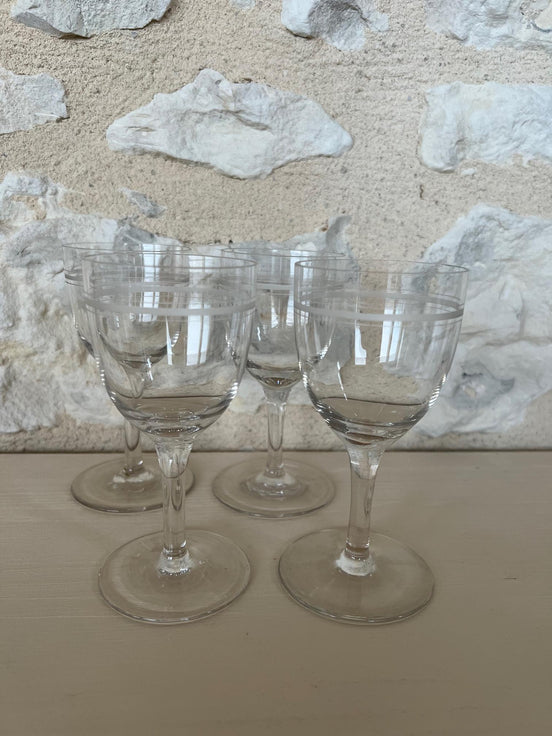 A Set of Four Etched Wine Glasses